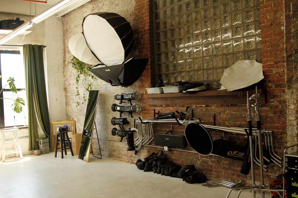 Studio equipment wall with softboxes and stands